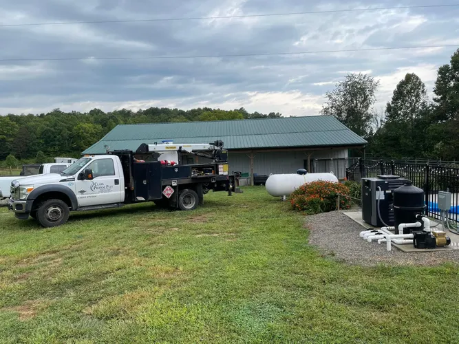 Clark Propane Plus technician installing an underground gas line for a backyard firepit